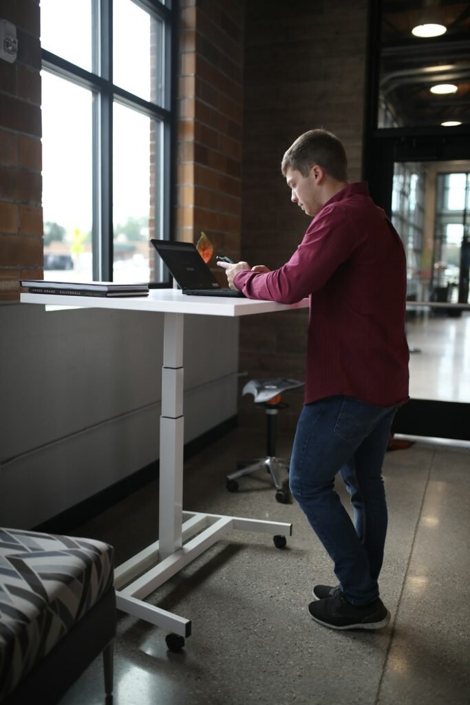 Person using a standing desk setup during an active workday