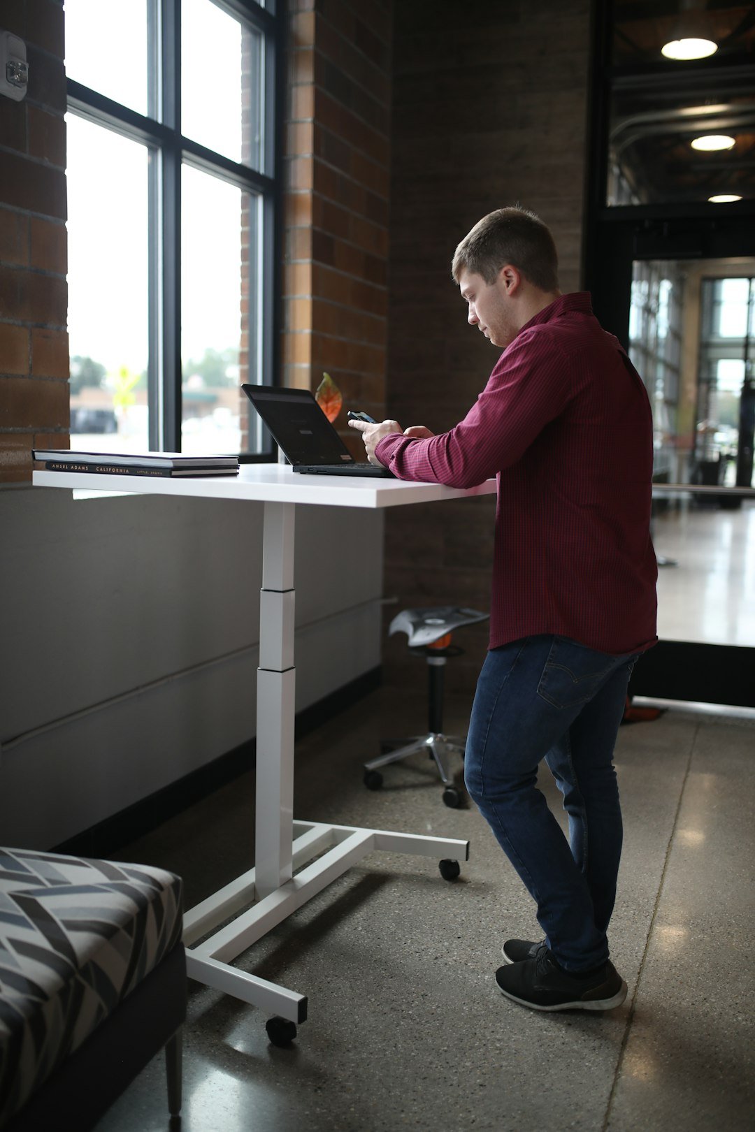 Person using a standing desk setup during an active workday